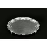 AN EDWARDIAN SILVER SALVER, of lobed outline with gadrooned and mask border, on shaped feet, by John