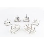 A PAIR OF SILVER FIVE BAR TOAST RACKS, by D & J Welby Ltd, London 1931, 14cm long; three other pairs
