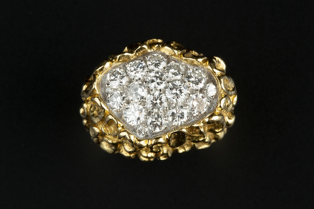 A DIAMOND DRESS RING BY KUTCHINSKY, the abstract textured mount centred with a 'pool' of pavé set
