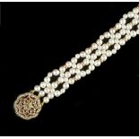 A CULTURED PEARL BRACELET WITH GEM SET CLASP, designed as a lattice of graduated cultured pearls
