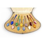 A SET OF TWELVE CONTINENTAL SILVER GILT AND VARI-COLOURED ENAMEL COFFEE SPOONS, import marks for