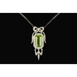 A PERIDOT AND DIAMOND PENDANT NECKLACE, the rectangular step-cut peridot bordered by rose-cut