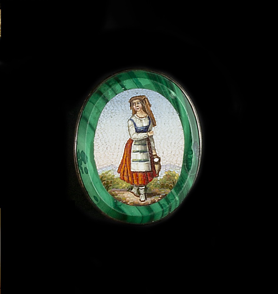 A 19TH CENTURY OVAL MICROMOSAIC PANEL, depicting a Swiss maiden in peasant dress within a