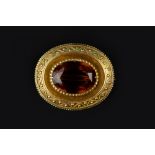 A VICTORIAN CITRINE PANEL BROOCH/PENDANT, the oval mixed-cut citrine bordered by ropetwist