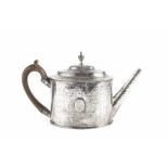 A GEORGE III SILVER OVAL TEAPOT, engraved with a repeated stylised design, with beaded borders,
