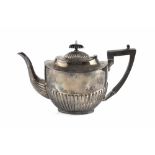 A SILVER TEAPOT, of half lobed form, with ebonised handle and knop, by Cooper Bros & Sons Ltd,