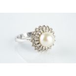 A CULTURED PEARL AND DIAMOND CLUSTER RING, modelled as a flowerhead, the central cultured pearl
