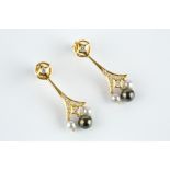 A PAIR OF CULTURED PEARL AND DIAMOND EAR PENDANTS, each suspending a trio of black and grey cultured