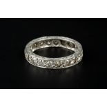 A DIAMOND FULL HOOP ETERNITY RING, the scroll engraved hoop set throughout with round brilliant