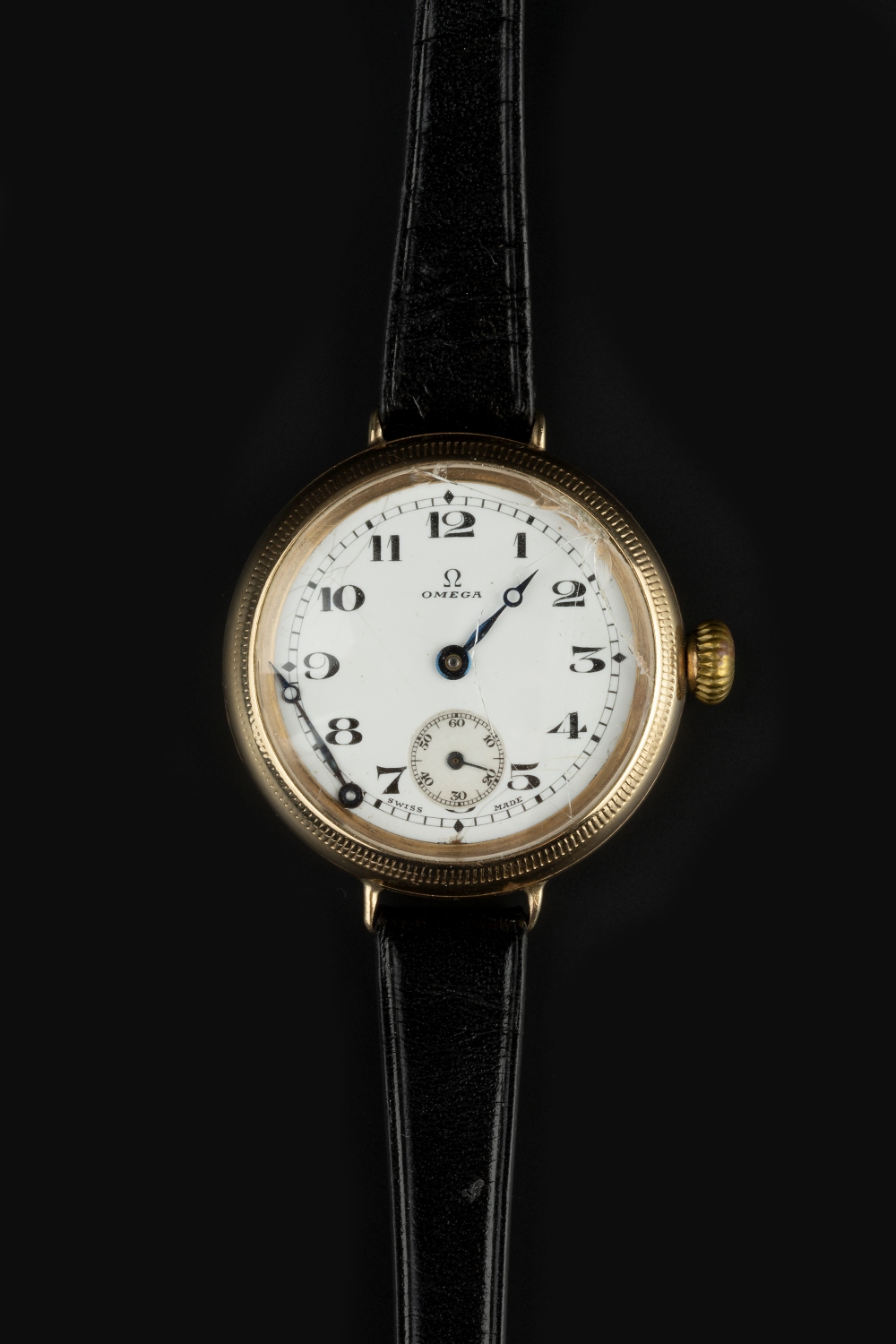 A GENTLEMAN'S 9CT GOLD WRISTWATCH BY OMEGA, the circular white enamel dial with Arabic numerals,