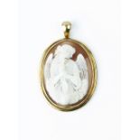 A VICTORIAN SHELL CAMEO PENDANT, the oval shell cameo carved to depict a winged goddess holding a