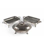 A PAIR OF 19TH CENTURY SILVER PLATED RECTANGULAR TWIN HANDLED WARMING DISHES, on foliate scroll