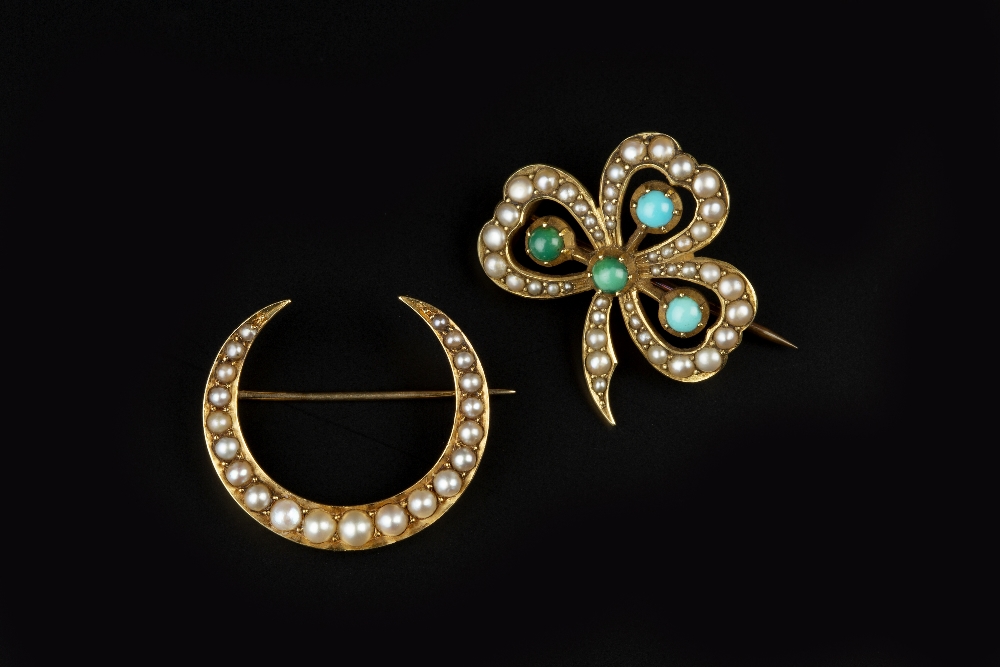 TWO HALF PEARL SET BROOCHES, the first a turquoise and half pearl set shamrock brooch, of openwork