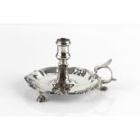 A GEORGE II SILVER CHAMBERSTICK, with scallop and scroll cast border, on scalloped feet, replacement