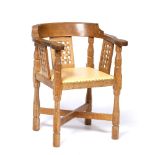 Robert Thompson of Kilburn (1876-1955) Mouseman monk's chair oak, the curved back with woven design,