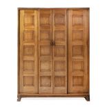 Peter Waals (1870-1937) Wardrobe walnut, panelled front with four sliding doors, on shaped chamfered