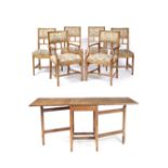 Peter Waals (1870-1937) Drop-leaf dining table and six chairs oak, on chamfered tapering legs and