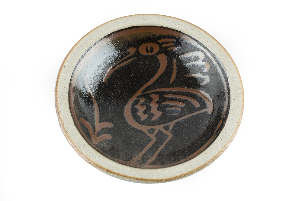 Seth Cardew (b.1954) Dish tenmoku glaze, decorated with a bird 23.5cm across.