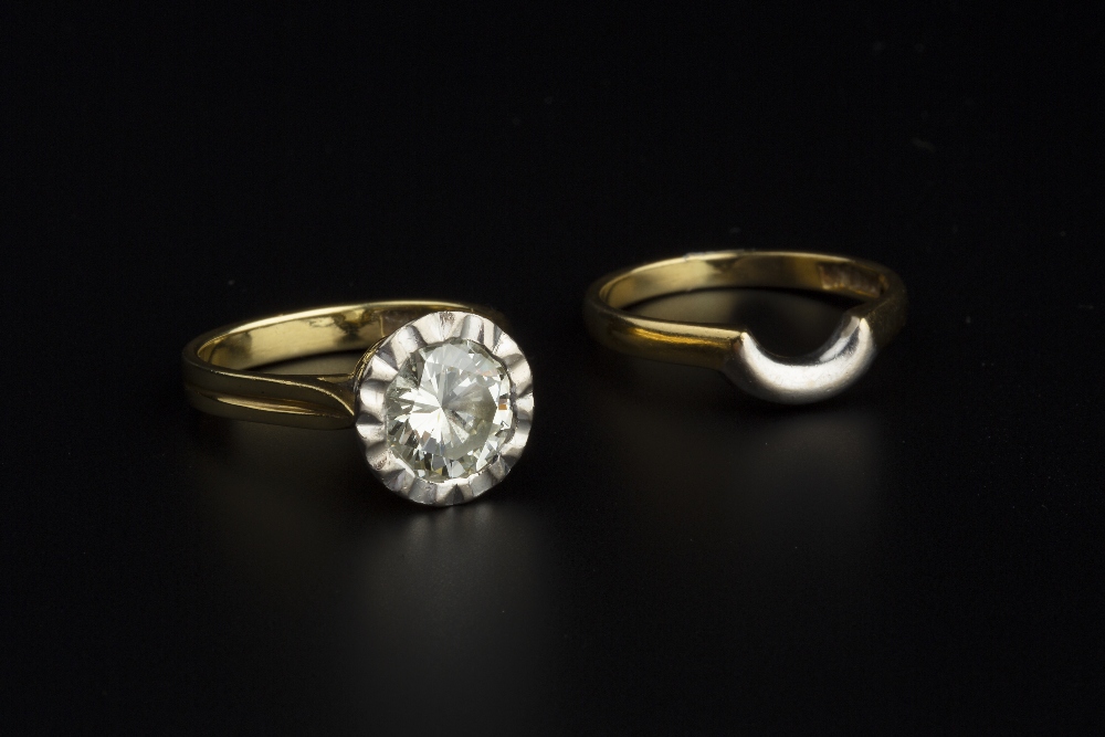 A DIAMOND SINGLE STONE RING, the round brilliant-cut diamond in fluted collet setting, between