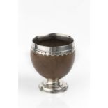 AN 18TH CENTURY SILVER MOUNTED COCONUT CUP, the shaped rim with indistinct maker's initials S.