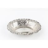 A LATE VICTORIAN SILVER OVAL DISH, pierced and repoussé decorated with flowers and 'C' scrolls, by