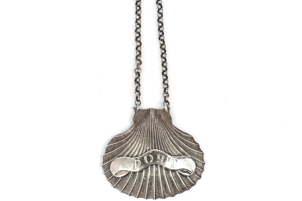 A GEORGE III SILVER DECANTER LABEL FOR PORT, in the form of a scallop shell, by Matthew Linwood,