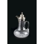 A MID VICTORIAN SILVER MOUNTED CLARET JUG, with star cut baluster body, the domed hinged cover and