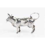 A LATE 19TH CENTURY CONTINENTAL SILVER SMALL COW CREAMER, the hinged lid embossed with a fly,