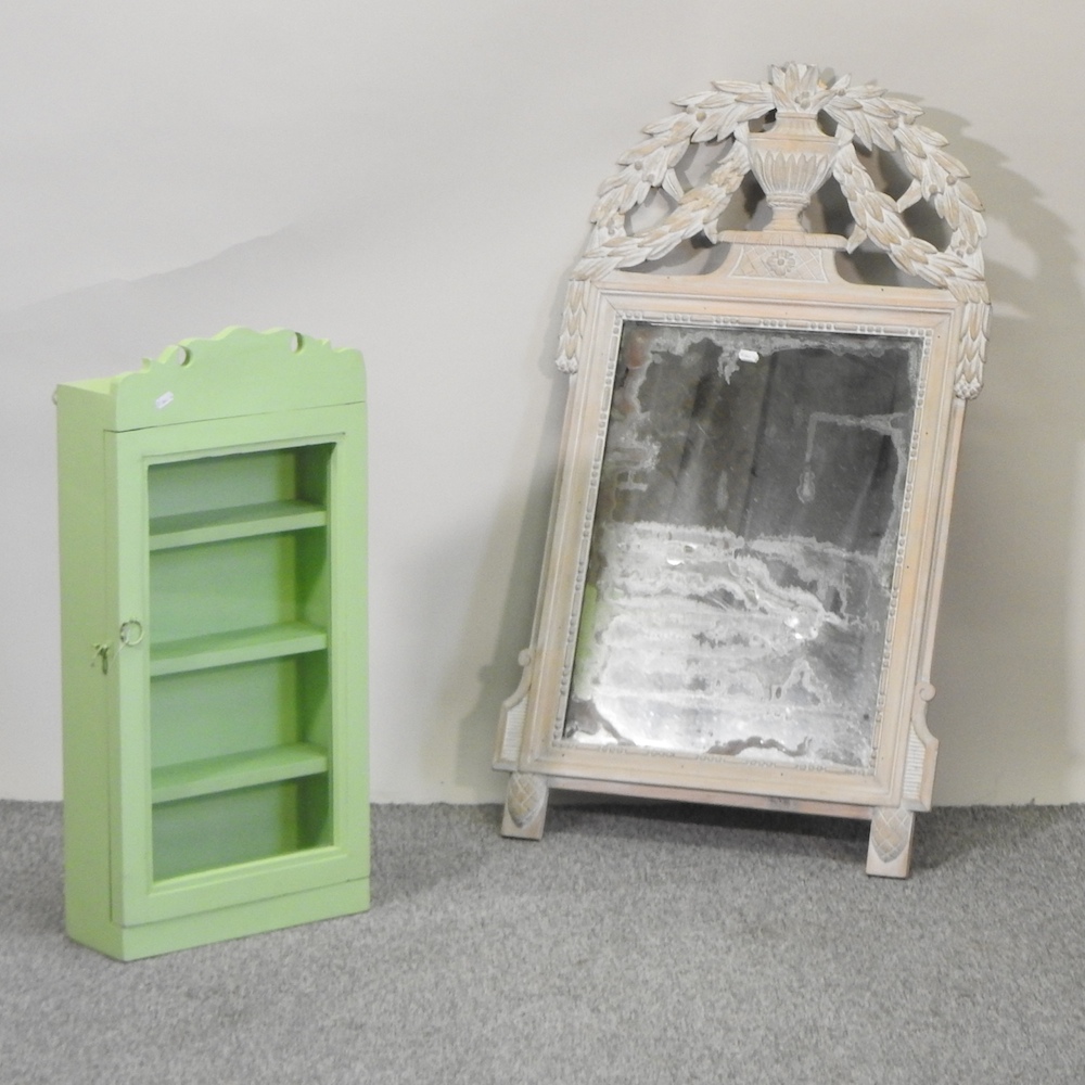 A painted wall mirror, with a scrolled cresting, 105 x 61cm,