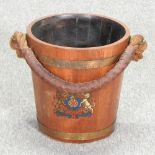 A 19th century style coopered oak fire bucket, painted with a crest,