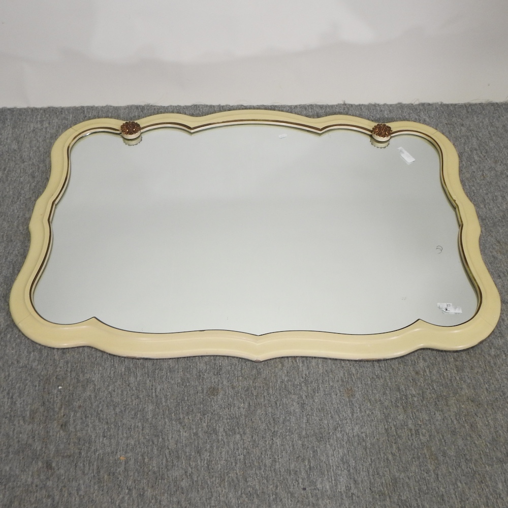 A cream painted wall mirror, with gilt decoration,