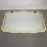 A cream painted wall mirror, with gilt decoration,