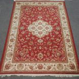 A Keshan style carpet, with floral design on red ground,