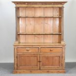 A Victorian pine dresser, with carved decoration,