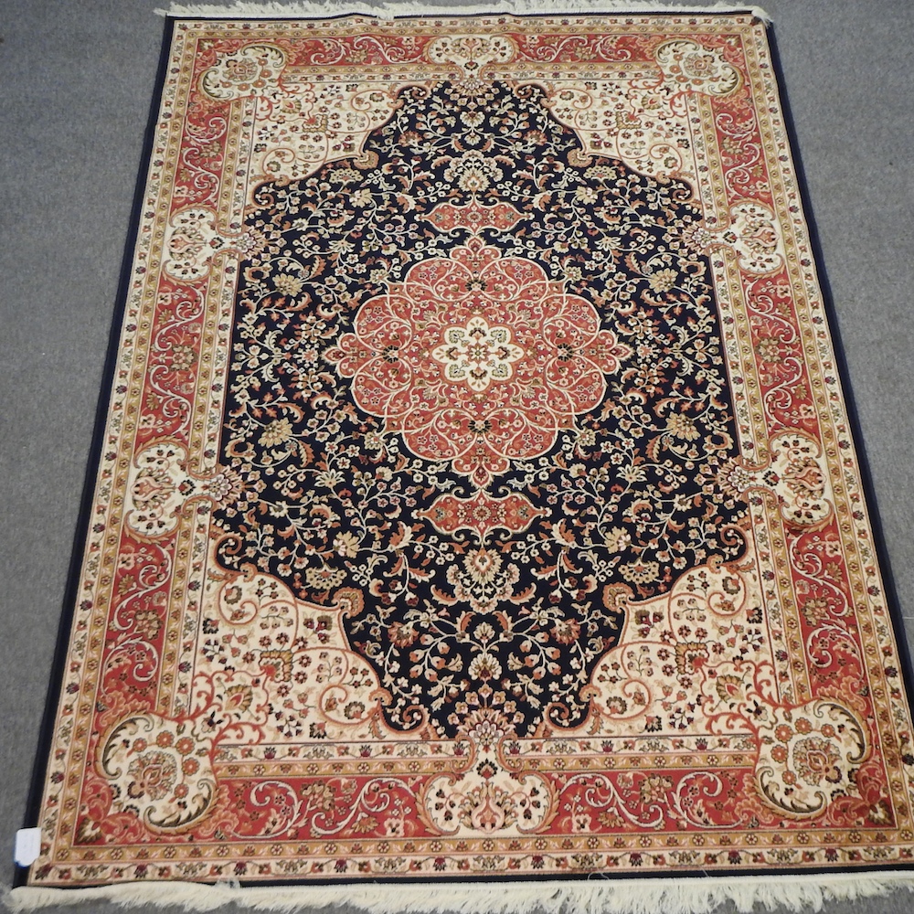 A Keshan style carpet, with floral design on blue ground,