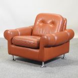 A 1960's tan leather upholstered armchair