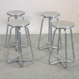 A set of four aluminium and tubular steel stools,