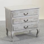 A grey painted French style chest, containing three drawers,