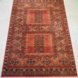 A large woollen carpet on a red ground,