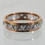 An 18 carat two colour gold eternity ring,