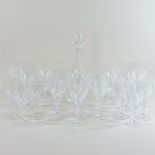 A collection of cut glass wine glasses and a decanter