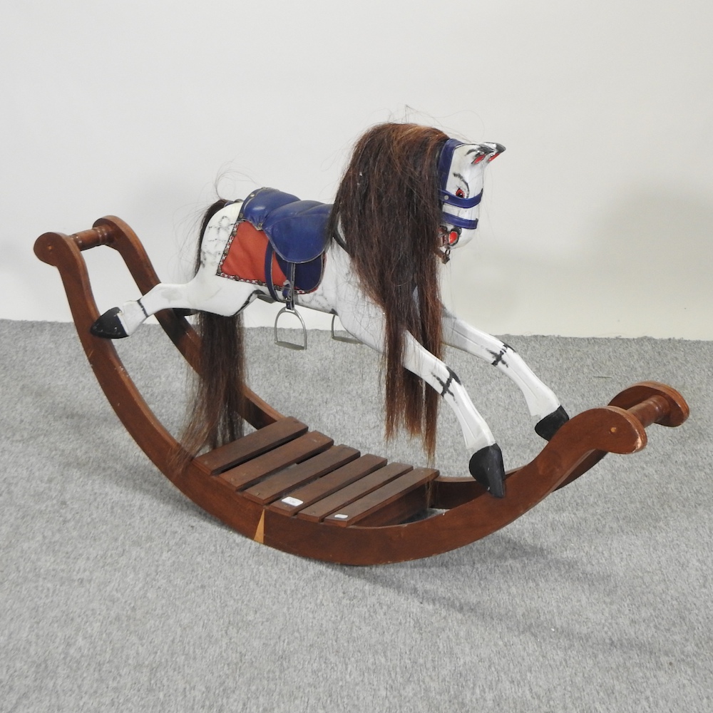 A 20th century painted wooden rocking horse, by Lines Bros,