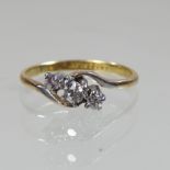 An 18 carat gold three stone diamond ring