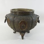 A Chinese bronze jardiniere, relief decorated with animals,