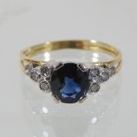 An 18 carat gold sapphire ring, with diamond shoulders,