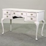 A white painted dressing table, on cabriole legs,