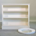 A cream painted dwarf open bookcase, 122cm,