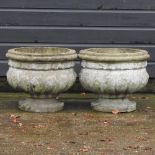 A pair of reconstituted circular planters,
