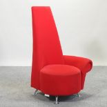 A modern red velvet upholstered high back corner chair