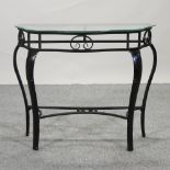 A metal console table, with a glass top,